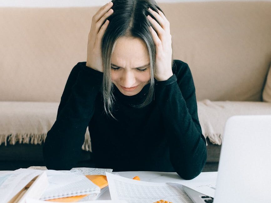 exhausted woman holding her head