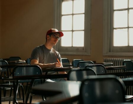 university student studying in empty classroom