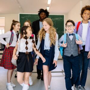 teacher with the students walking in the school