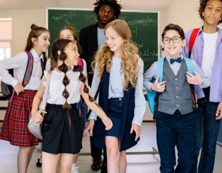 teacher with the students walking in the school