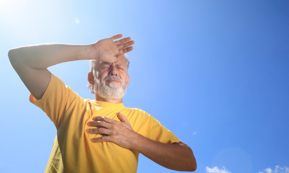 Senior man suffering from heat stroke outdoors