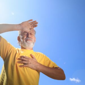 Senior man suffering from heat stroke outdoors