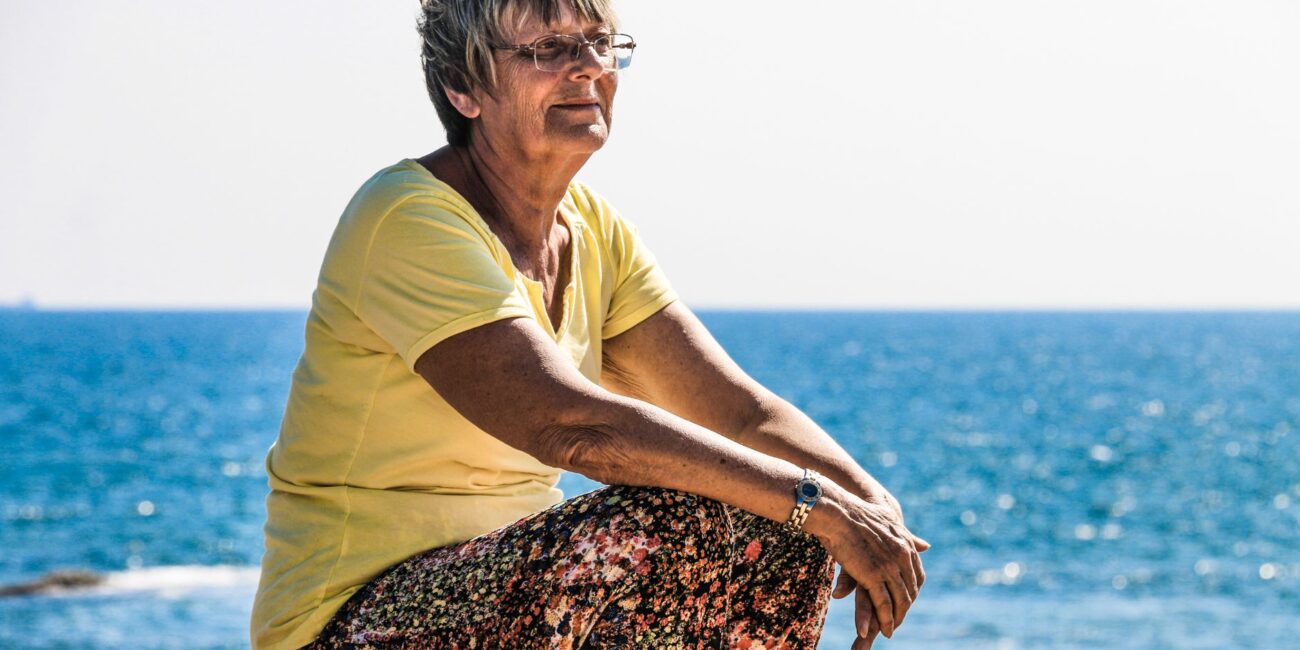 woman sitting on beach shore