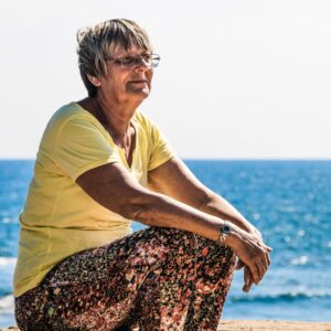 woman sitting on beach shore