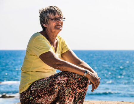 woman sitting on beach shore